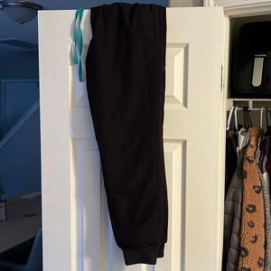 Black figs scrubs jogger style with blue waist tie.